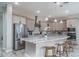 Bright kitchen with stainless steel appliances, light wood cabinets, and a center island with bar stool seating at 15233 W Baden St, Goodyear, AZ 85338