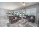 Spacious living room with comfortable seating, neutral colors, and a view of the backyard patio and pool at 15233 W Baden St, Goodyear, AZ 85338