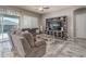 Cozy living room with comfortable seating, a ceiling fan, and sliding doors to the outdoor patio at 15233 W Baden St, Goodyear, AZ 85338