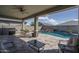 Covered travertine patio overlooking the pool at 15233 W Baden St, Goodyear, AZ 85338