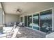 Covered travertine patio with ceiling fan and open views of the pool at 15233 W Baden St, Goodyear, AZ 85338