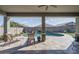 Covered patio with a view of the pool area and lush landscaping perfect for outdoor entertaining at 15233 W Baden St, Goodyear, AZ 85338