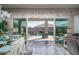 An inside view looking out to the private pool and patio area through large sliding glass doors at 15233 W Baden St, Goodyear, AZ 85338