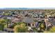 Aerial view of a desert home featuring a red-tiled roof with solar panels and lush landscaping at 15837 W Bonitos Dr, Goodyear, AZ 85395