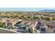 Aerial view of a home with a well-kept yard, desert landscaping, and community, set against a mountain backdrop at 15837 W Bonitos Dr, Goodyear, AZ 85395