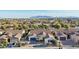 Stunning aerial view of a residential area with a clear shot of the houses and a distant mountain range at 15837 W Bonitos Dr, Goodyear, AZ 85395