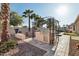 View of an outdoor kitchen area, a built-in grill, stone countertop, and desert landscaping and pavers at 15837 W Bonitos Dr, Goodyear, AZ 85395