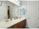 Bathroom featuring dual sinks, wood cabinetry, and a large mirror at 15837 W Bonitos Dr, Goodyear, AZ 85395