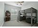 Bedroom with a loft bed, grey color scheme, and shuttered window at 15837 W Bonitos Dr, Goodyear, AZ 85395