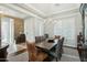 Elegant dining room with chandelier, shuttered windows, and decorative stone accent wall at 15837 W Bonitos Dr, Goodyear, AZ 85395