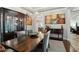 Formal dining room featuring a decorative chandelier, custom china cabinet, and stylish decor at 15837 W Bonitos Dr, Goodyear, AZ 85395