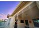 Covered patio area showcasing window and door features plus an entertainment center with a television and mounted speaker at 15837 W Bonitos Dr, Goodyear, AZ 85395