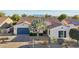 Lovely home featuring desert landscaping, a blue garage door, and mountain views in the distance at 15837 W Bonitos Dr, Goodyear, AZ 85395