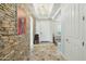 Inviting foyer features a stone accent wall, tile flooring, and views into other living spaces at 15837 W Bonitos Dr, Goodyear, AZ 85395