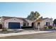 Charming home exterior with desert landscaping, a mature palm tree, and a blue garage door at 15837 W Bonitos Dr, Goodyear, AZ 85395