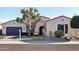 Home featuring a wide driveway, desert landscaping, and a charming facade at 15837 W Bonitos Dr, Goodyear, AZ 85395