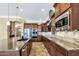 Modern kitchen featuring stainless steel appliances, granite counters, and custom cabinetry at 15837 W Bonitos Dr, Goodyear, AZ 85395