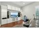 Relaxing living room featuring stylish built-ins, a mounted TV, and comfortable seating at 15837 W Bonitos Dr, Goodyear, AZ 85395