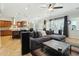 Open concept living room with tile flooring, fan, and view into the kitchen at 15837 W Bonitos Dr, Goodyear, AZ 85395