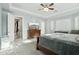 Inviting main bedroom featuring a large TV, dresser, and access to the ensuite bathroom at 15837 W Bonitos Dr, Goodyear, AZ 85395