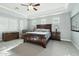 Spacious main bedroom with a ceiling fan, tray ceiling, and abundant natural light from shuttered windows at 15837 W Bonitos Dr, Goodyear, AZ 85395