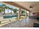 View of the pool area featuring a waterfall feature from an outdoor living space with travertine flooring at 15837 W Bonitos Dr, Goodyear, AZ 85395