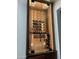 Elegant climate-controlled wine storage with glass door and built-in shelving at 15837 W Bonitos Dr, Goodyear, AZ 85395