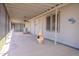 Covered back porch with neutral siding, ceiling fan, and painted concrete flooring at 1612 N 201St Ave, Buckeye, AZ 85396