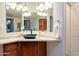 Modern bathroom featuring a sleek countertop, dark wood cabinets, and a stylish sink at 1612 N 201St Ave, Buckeye, AZ 85396