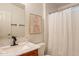 Cozy bathroom with white shower curtain, stylish vanity, neutral artwork, and sleek fixtures at 1612 N 201St Ave, Buckeye, AZ 85396