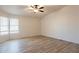 Bright and airy bedroom with neutral walls, plank flooring and windows for lots of natural light at 1612 N 201St Ave, Buckeye, AZ 85396