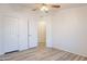 Well-lit bedroom featuring wood-look flooring and closet doors for tidy storage solutions at 1612 N 201St Ave, Buckeye, AZ 85396