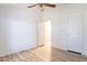 Spacious bedroom with wood-look floors, ceiling fan, and neutral walls, offering a blank canvas at 1612 N 201St Ave, Buckeye, AZ 85396