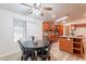 Dining area features a dark metal table and chairs and overlooks the kitchen and features natural light at 1612 N 201St Ave, Buckeye, AZ 85396