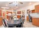 Open concept dining area with views of the kitchen and built-in office space and a black metal dining set at 1612 N 201St Ave, Buckeye, AZ 85396