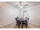 Bright dining area with modern lighting and a dark wood table with four black metal chairs at 1612 N 201St Ave, Buckeye, AZ 85396