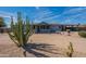 Beautiful single-story home with desert landscaping and large cactus in the front yard at 1612 N 201St Ave, Buckeye, AZ 85396