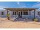 Inviting front porch with covered entrance, decorative plants, and brick pathway at 1612 N 201St Ave, Buckeye, AZ 85396