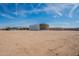 Wide open land featuring a metal shed and solar panels under a beautiful blue sky at 1612 N 201St Ave, Buckeye, AZ 85396