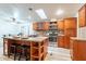 Kitchen with stainless steel appliances, wood cabinets, granite countertops and a center island with bar stool seating at 1612 N 201St Ave, Buckeye, AZ 85396