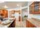 Spacious kitchen features wood cabinets, center island with bar seating, granite countertops and modern stainless steel faucet at 1612 N 201St Ave, Buckeye, AZ 85396