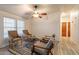 Inviting living room featuring comfortable seating and a modern ceiling fan at 1612 N 201St Ave, Buckeye, AZ 85396