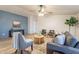 Bright and airy living room with stylish furnishings, a ceiling fan, and wood-look flooring at 1612 N 201St Ave, Buckeye, AZ 85396