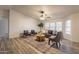 Comfortable living room with a plush sofa, area rug, ceiling fan, and natural light at 1612 N 201St Ave, Buckeye, AZ 85396