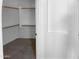 Walk-in closet with built-in shelving and neutral carpet at 16472 W Tether Trl, Surprise, AZ 85387