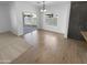 Dining area with dark cabinets, wood-look floors, and sliding glass door to the patio at 16472 W Tether Trl, Surprise, AZ 85387