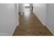 Hallway with beautiful wood-look tile flooring connects the living areas and bedrooms seamlessly at 16472 W Tether Trl, Surprise, AZ 85387