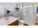 Modern bathroom featuring a glass shower, marble tile, and updated fixtures at 16585 W Harrison St, Goodyear, AZ 85338