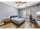 This bedroom features a ceiling fan, desk space, and natural light from the window at 16585 W Harrison St, Goodyear, AZ 85338