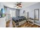 Cozy bedroom with a decorative ceiling fan, closet and dresser for ample storage at 16585 W Harrison St, Goodyear, AZ 85338